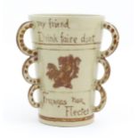 A beaker / tyg with three loop handles, the body with hand painted decoration depicting a lion