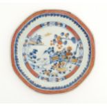 A Chinese plate / dish of octagonal form decorated in the Imari palette depicting a garden terrace