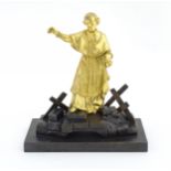 A late 19th / early 20thC Continental bronze sculpture depicting an ormolu Cardinal figure on a