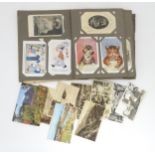 A late 19thC - early 20thC postcard album containing pictorial and photographic postcards,