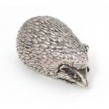 A white metal novelty pill box modelled as a hedgehog. Approx. 1 1/2" long Please Note - we do not