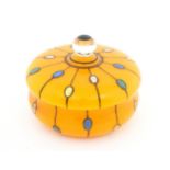 A Continental retro glass powder bowl with orange body and cover and painted detail, inspired by the