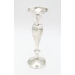 A white metal bud vase marked 'Silver' . Approx. 7 1/4" high. Please Note - we do not make reference