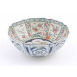 An Oriental famille rose bowl of octagonal form decorated with flowers, foliage and butterflies /