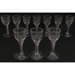 Ten Georgian drinking glasses with air twist detail to stems, the bowls engraved with floral and