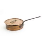 A large Continental copper saute pan with cast iron handle, the cover with a brass handle. Stamped