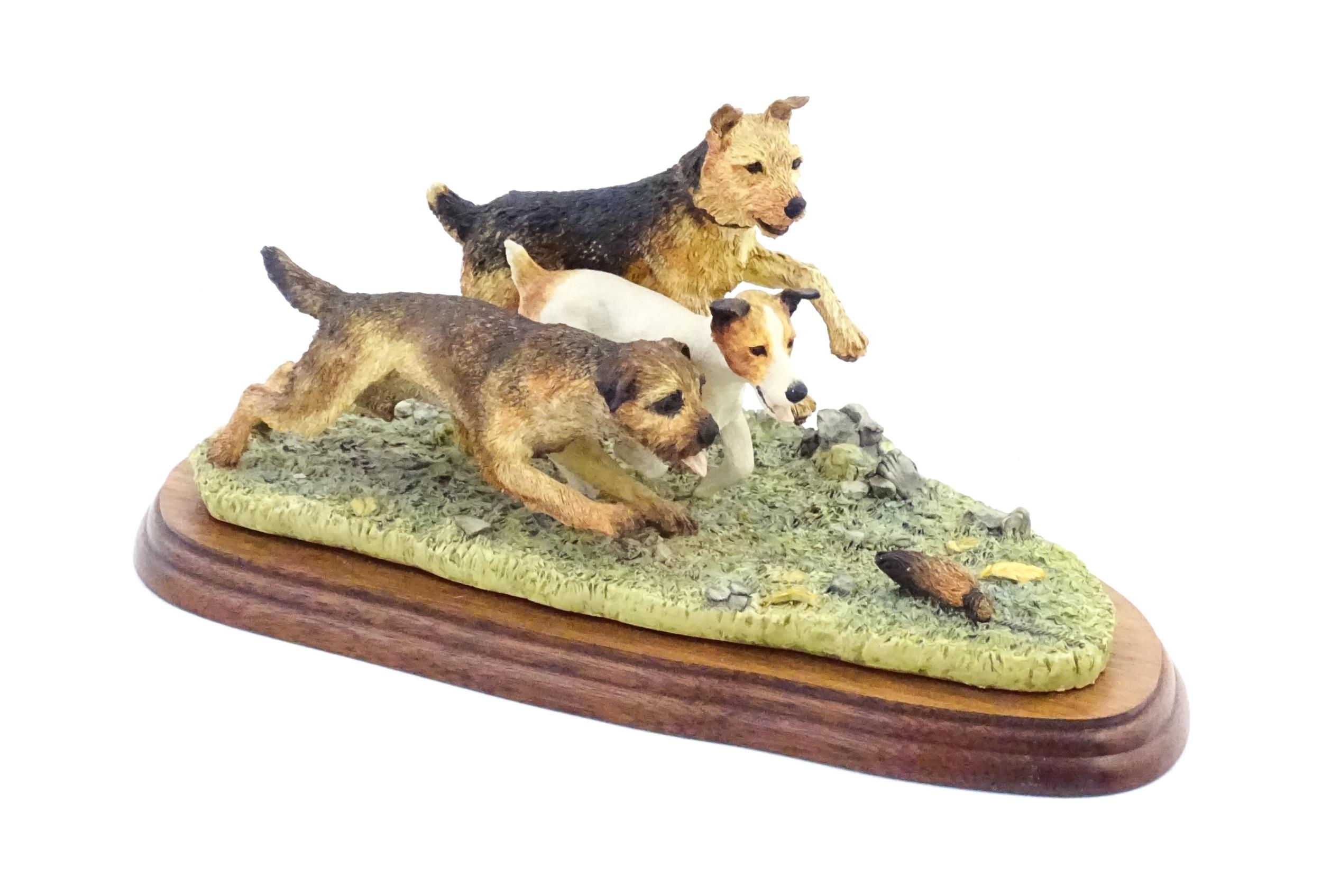 A Border Fine Arts model Terrier Race, by Margaret Turner, model no. B0242. Within a glazed case.