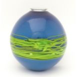 An art / studio glass vase by Bob Crooks of globular form trailed with green banding over a blue
