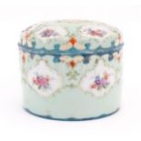 A Continental pot and cover decorated with hand painted floral vignettes. Approx. 4" high Please