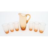 A peach glass lemonade set comprising jug and six glasses. Jug approx. 9 1/2" high (7) Please Note -