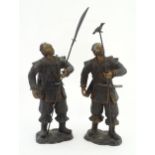 A pair of Japanese bronze sculptures depicting hunters / warriors, each with a quiver of arrows