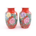 A pair of Chinese baluster vases, the red ground decorated with peony flowers and foliage. Character