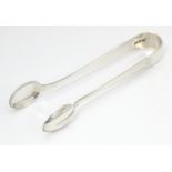 Silver sugar tongs hallmarked London 1909, maker Holland, Aldwinckle & Slater. Approx. 4 1/4" long