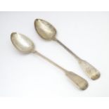 Two silver fiddle pattern serving / basting spoons one hallmarked London 1817 the other London 1820.
