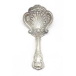A Victorian silver caddy spoon with shell formed bowl and scroll detail. Hallmarked Birmingham
