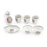 A quantity of Chinese export tea wares with armorial decoration and floral borders, to include tea