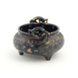 A Chinese censer with twin handles of stylised salamander form with relief banded decoration.