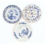 Three Chinese plates / dishes comprising a blue and white example decorated with flowers, foliage,