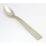 A Queen Elizabeth II Scottish silver serving spoon with textured and gilt detail to handle,