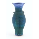 A 20thC studio pottery barium glaze vase by Simon Shaw, with a bulbous body and a flared rim, the