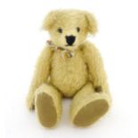 Toy: A 20thC mohair teddy bear with stitched nose and mouth, pad paws, and articulated head and