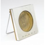An easel back photograph frame of squared form with a silver surround hallmarked Sheffield 2000,