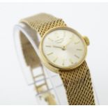 A ladies 9ct gold cased Longines wristwatch with 9ct gold strap. Watch dial approx. 5/8" diameter