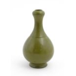 A Chinese bottle vase with tea coloured glaze. Character marks under. Approx. 11" high Please Note -