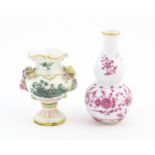 Two small Continental vases comprising a double gourd vase with scrolling floral and foliate detail,