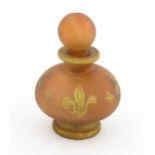 A glass scent / perfume bottle by Jenny Blair with gilt fleur de lys. Approx. 2 3/4" high Please