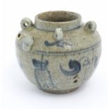 An Oriental stoneware water pot / jar with four loop handles, a spout and crackle glaze with blue