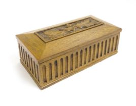 A 20thC oak box of rectangular form with carved thistle detail. Approx. 3 1/2" high x 10" wide x