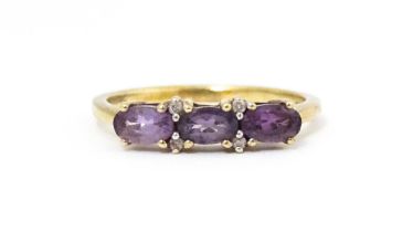 A 9ct gold ring set with amethyst and diamond. Ring size approx. N. Please Note - we do not make