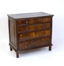 An early / mid 18thC oak and walnut chest of drawers, the moulded top above two short over three