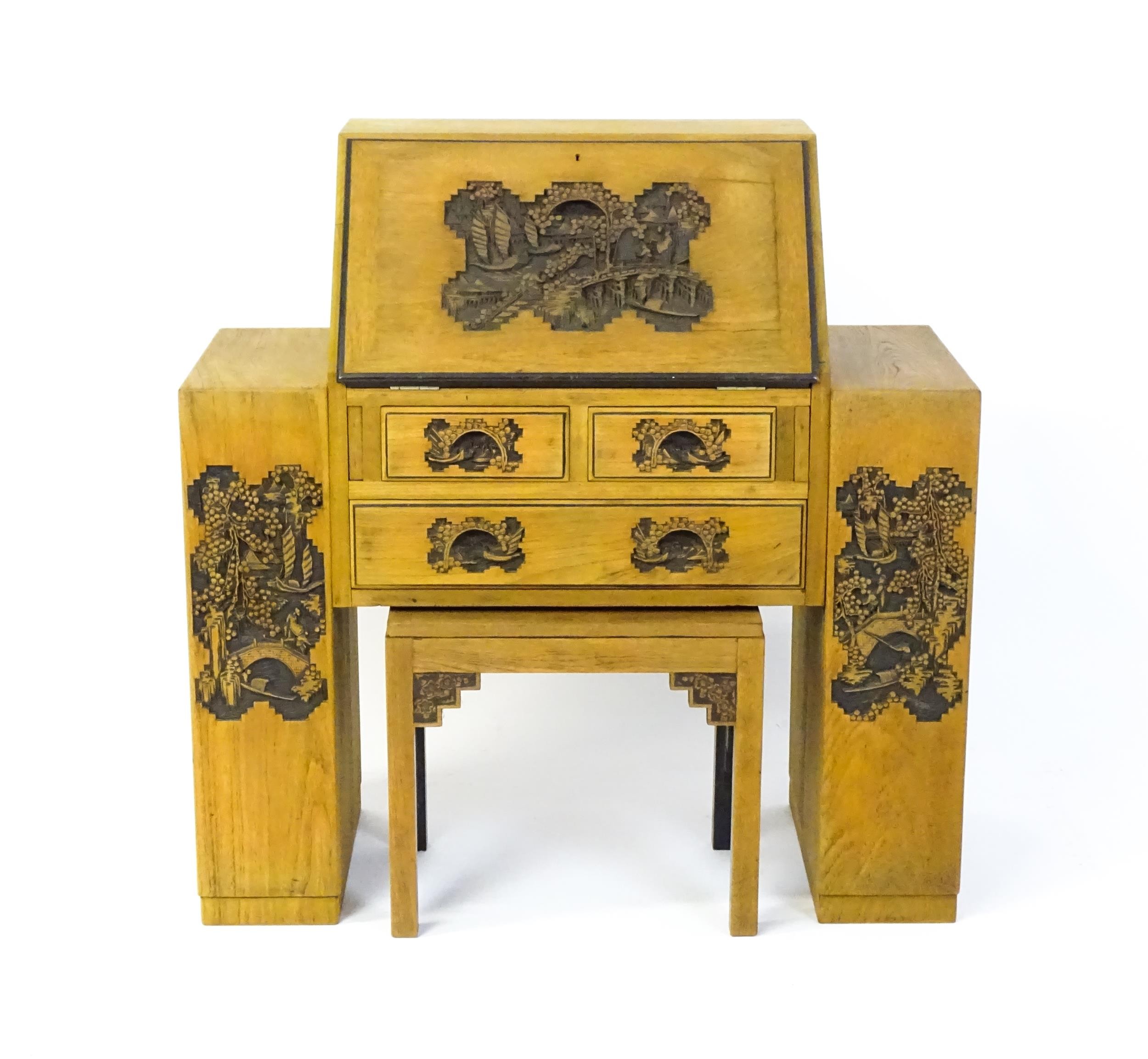An early / mid 20thC Teak bureau accompanied by a stool, with carved oriental scenes to the front, - Image 8 of 12
