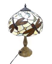 A late 20thC table lamp in the Tiffany style with dragonfly detail to shade. Approx. 17" high Please