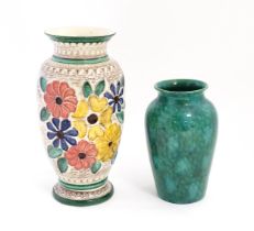 A West German vase decorated with flowers. Marked under. Together with another with a mottled