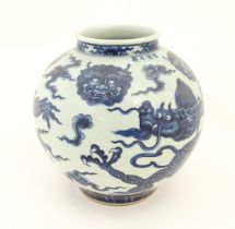 A Chinese blue and white vase of globular form decorated with dragons and masks amongst stylised