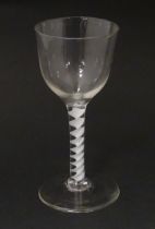 An 18thC wine glass with ogee bowl, multi-ply corkscrew twist stem. Approx. 6 1/2" high Please