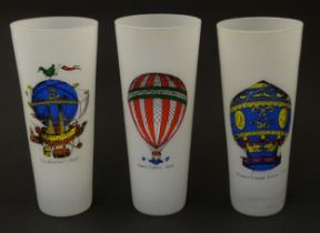 Three drinking glasses decorated with hot air balloons commemorating various early balloon