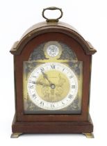 A small 20thC reproduction bracket clock, by Elliott of London, retailed by J & M Perkins. Having