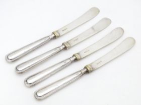 Four silver butter / tea knives hallmarked Sheffield 1923, maker William Yates Ltd. Approx. 6 1/2"