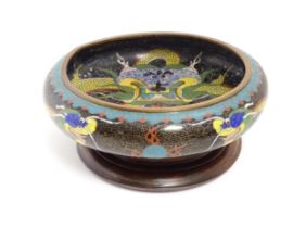 A Chinese cloisonne dish the black ground with dragon and flaming pearl decoration. Character