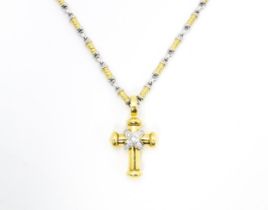 An 18ct yellow and white gold necklace with cross formed pendant set with diamonds. Chain approx.