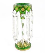 A Victorian green glass table lustre with gilt foliate decoration and clear glass drops. Approx 13
