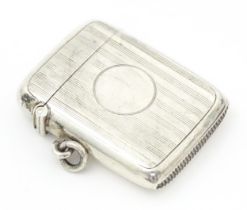 A silver vesta case with engine turned decoration, hallmarked Birmingham 1907, maker William