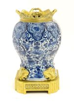 A blue and white baluster vase decorated with birds, flowers and foliage, with brass mounts. Approx.