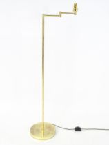 A brass standard lamp with adjustable arm. Approx 54" high Please Note - we do not make reference to