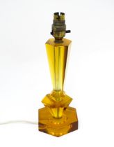 A mid century / retro table light with amber coloured lucite base of shaped form. Approx. 11" high