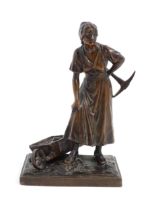 A 20thC cast sculpture depicting a female miner with an axe and a wheelbarrow of coal. Numbered 6129